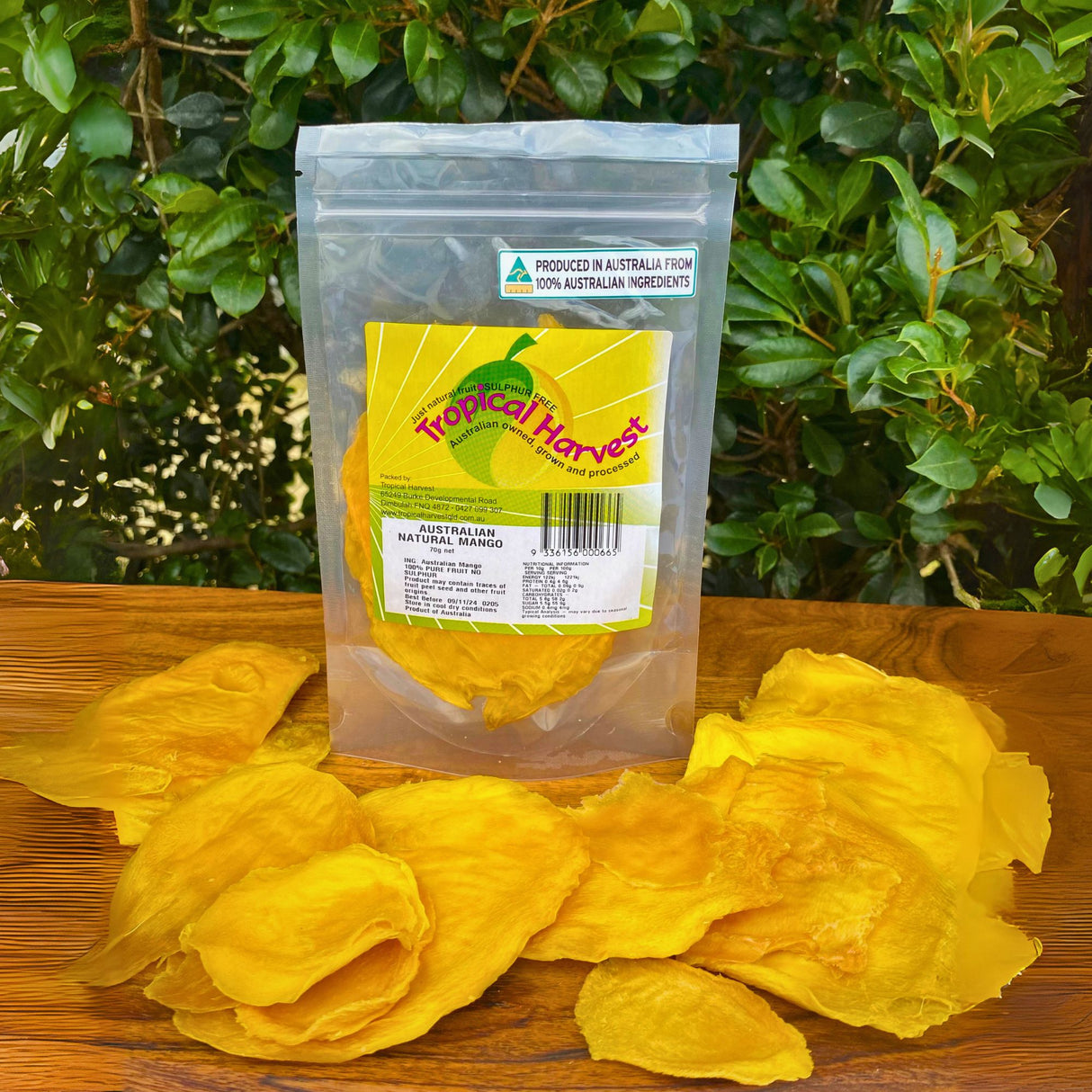 Small 70g pack of premium dried mango cheek slices made from 100% Australian mangoes, displayed with loose slices in front of resealable bag