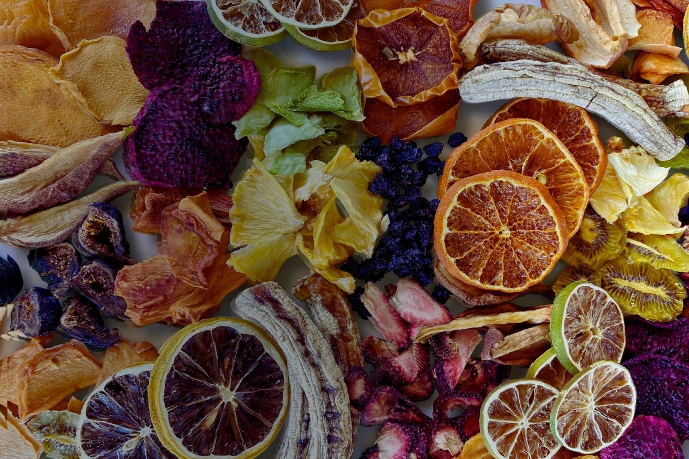 A colourful assortment of Australian dried fruits — including citrus, banana, berries, pineapple, fig, and mango — slow-dried and ready to eat.