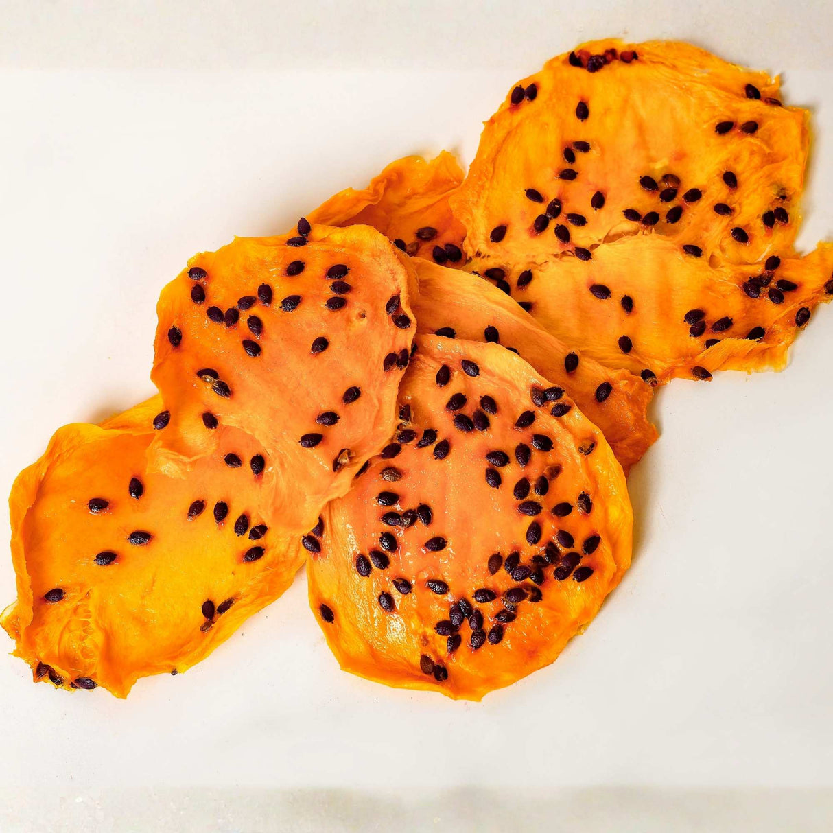 Australian dried mango with passionfruit pulp slices showing real passionfruit seeds and natural texture.