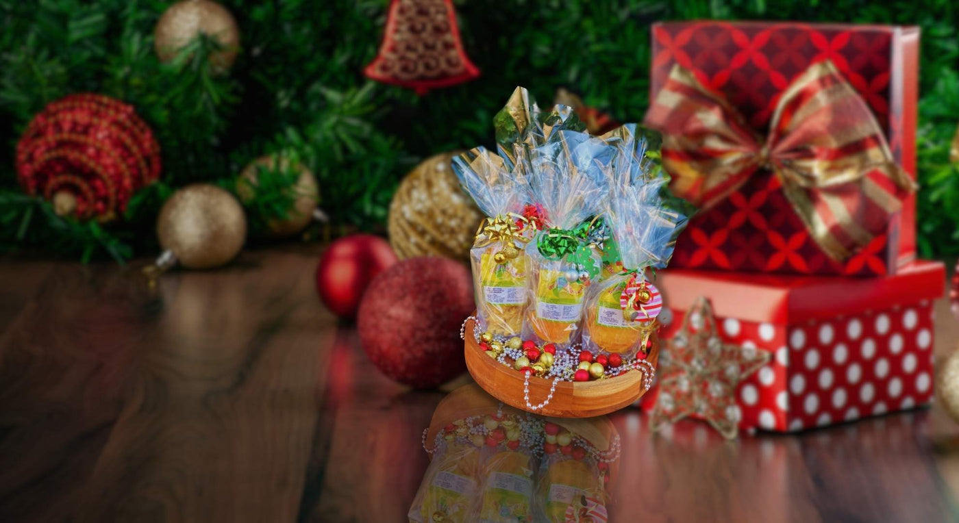 Festive Christmas dried fruit gift pack with mango, pineapple, and fruit mix in wooden bowl with decorations