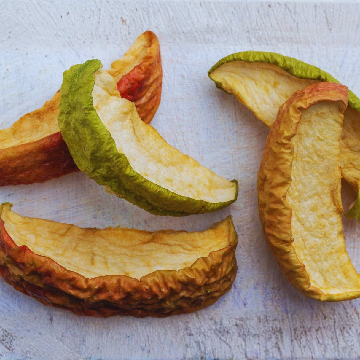 Dried apple slices on light background for healthy snacking and natural fruit snack