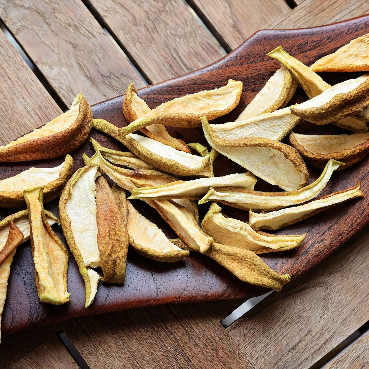 Dried pear slices served on wooden board for snacking and grazing platters