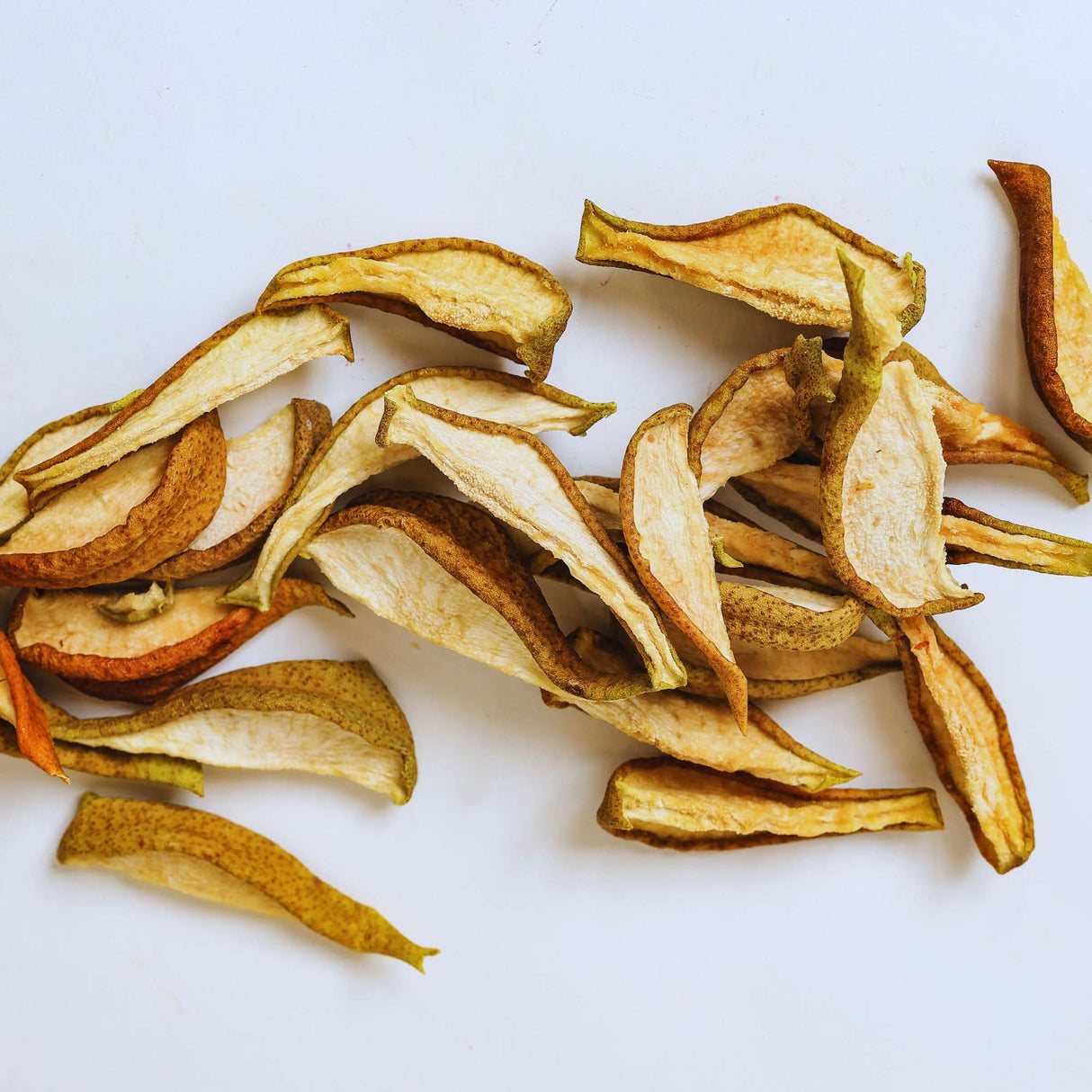 Dried pear slices on white background for healthy snacking and natural fruit snack