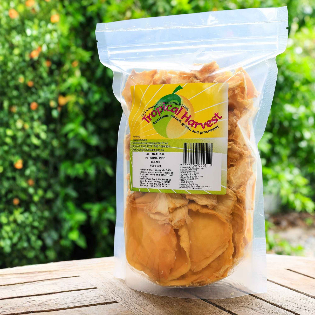 Premium dried fruit mix in resealable pack shown in natural outdoor setting, high quality real fruit snack