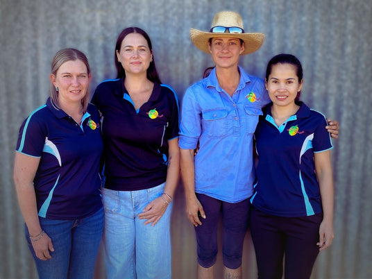 Tropical Harvest team in Queensland standing together, the people behind washing, slicing, drying, and packing Australian dried fruit.