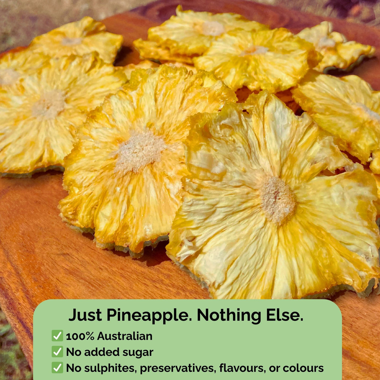 Tropical Harvest dried pineapple flowers with text overlay: "Just Pineapple. Nothing Else." No added sugar, sulphites, preservatives, or colours.