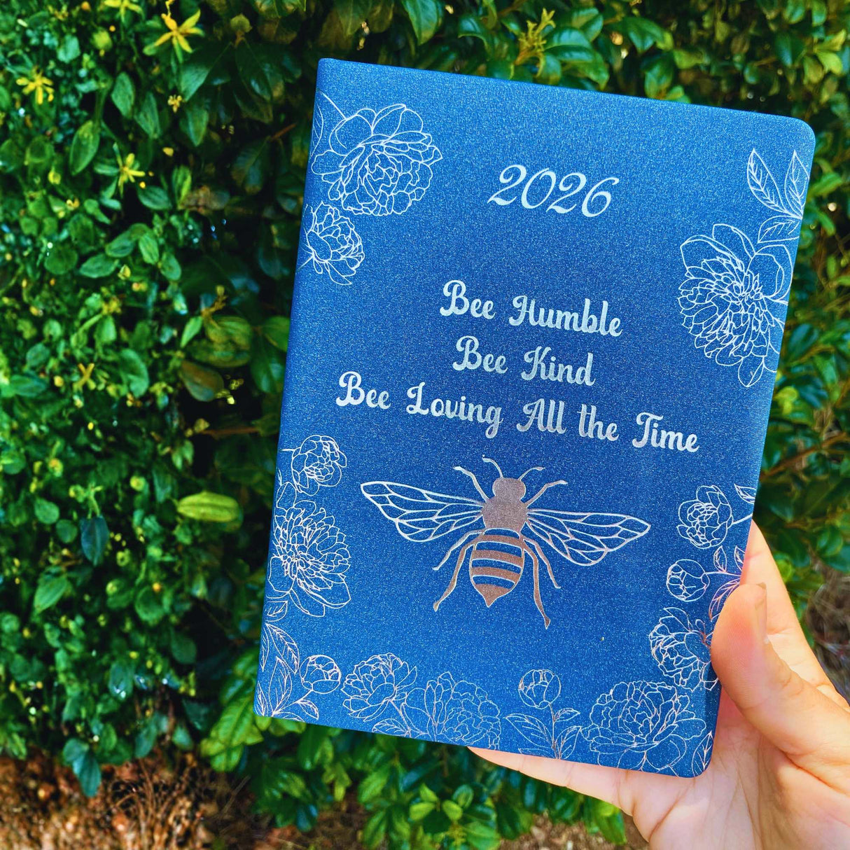 Close-up of 2026 diary with navy bee cover – Bee Humble, Bee Kind, Bee Loving All the Time