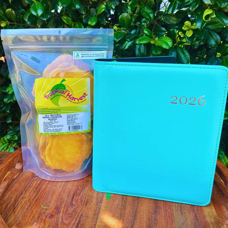 2026 planner and 350g bag of premium dried mango arranged on wooden surface
