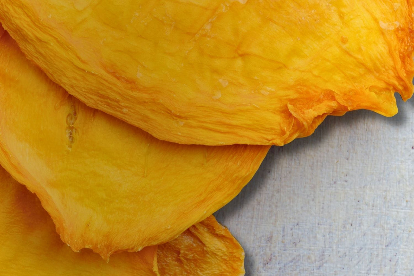 Close-up of slow-dried Australian mango slices – golden, chewy, and naturally sweet.