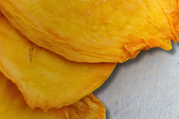 Close-up of slow-dried Australian mango slices – golden, chewy, and naturally sweet.