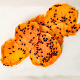 Australian dried mango with passionfruit pulp slices showing real passionfruit seeds and natural texture.
