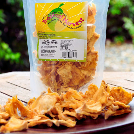150g pack of Tropical Harvest Australian dried pineapple with dried pineapple pieces on plate