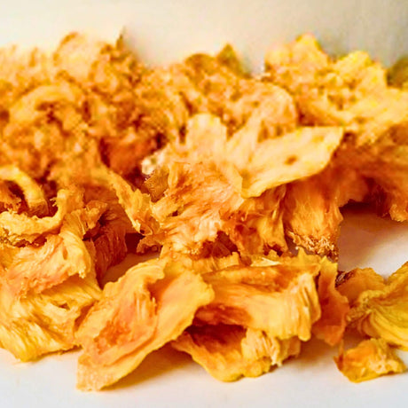 Close-up of chewy Tropical Harvest Australian dried pineapple pieces showing natural fruit texture