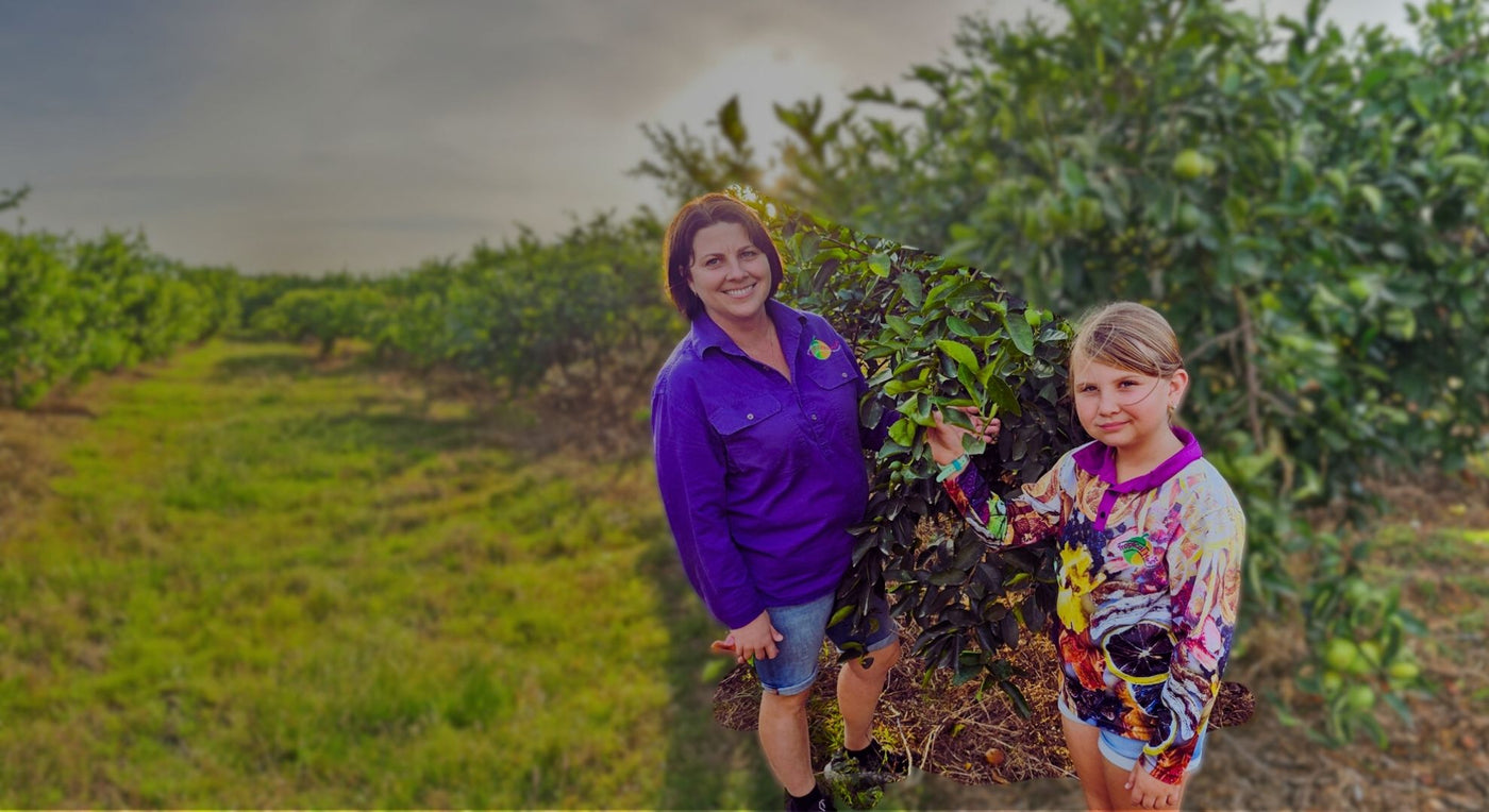 Janelle and daughter in the orchard at Tropical Harvest farm, Dimbulah QLD