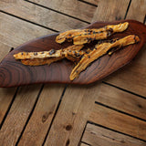 Dried banana passionfruit slices on wooden board showing natural tropical snack