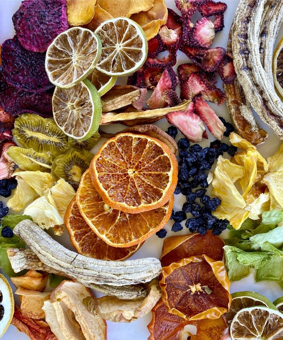 Close-up of colourful dried fruit slices – mango, orange, kiwi, pineapple, and banana – preservative-free snacks by Tropical Harvest.