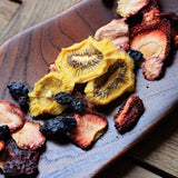 Dried fruit mix with kiwi strawberry and blueberry served on board for snacking and sharing