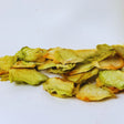 Dried honeydew melon slices on white background for healthy fruit snacking