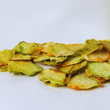 Dried honeydew melon slices on white background for healthy fruit snacking