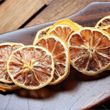 Dried lemon slices displayed on wooden surface for natural food styling and garnish use