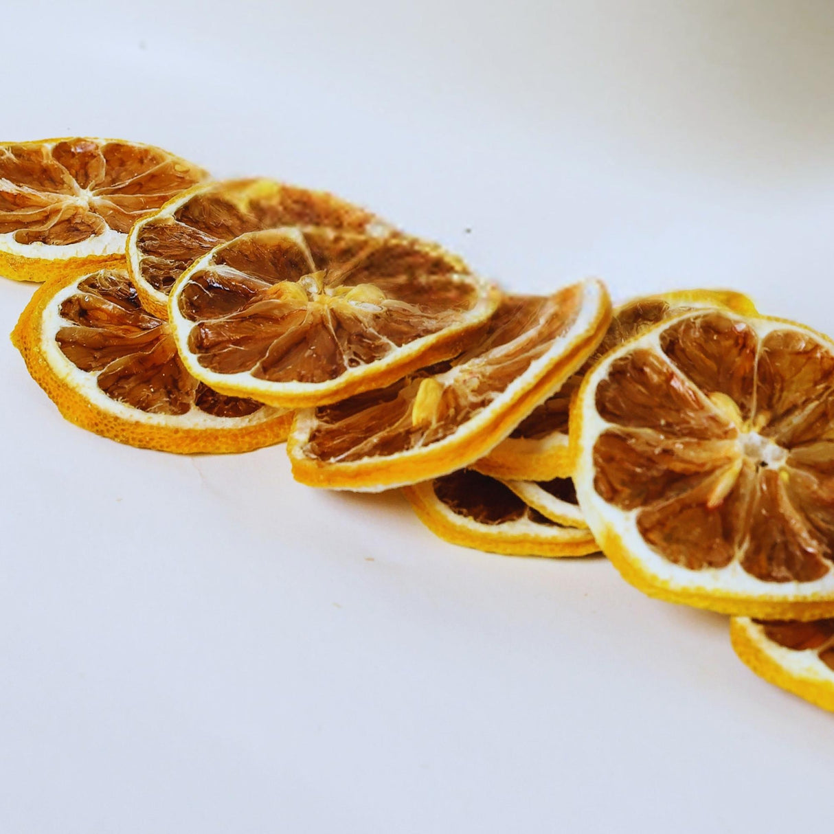 Dried lemon slices on white background ideal for water infusion, cocktails, and tea