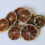 Dried lime slices on white background for cocktails water infusion and drink garnishes