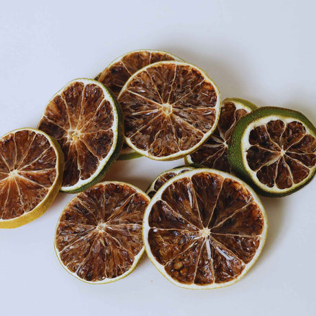 Dried lime slices on white background for cocktails water infusion and drink garnishes