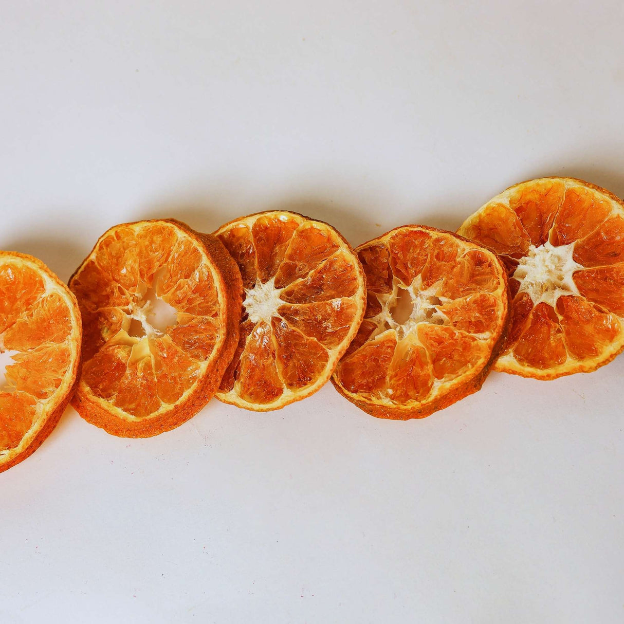 Dried mandarin slices on white background for snacking tea and drink garnish