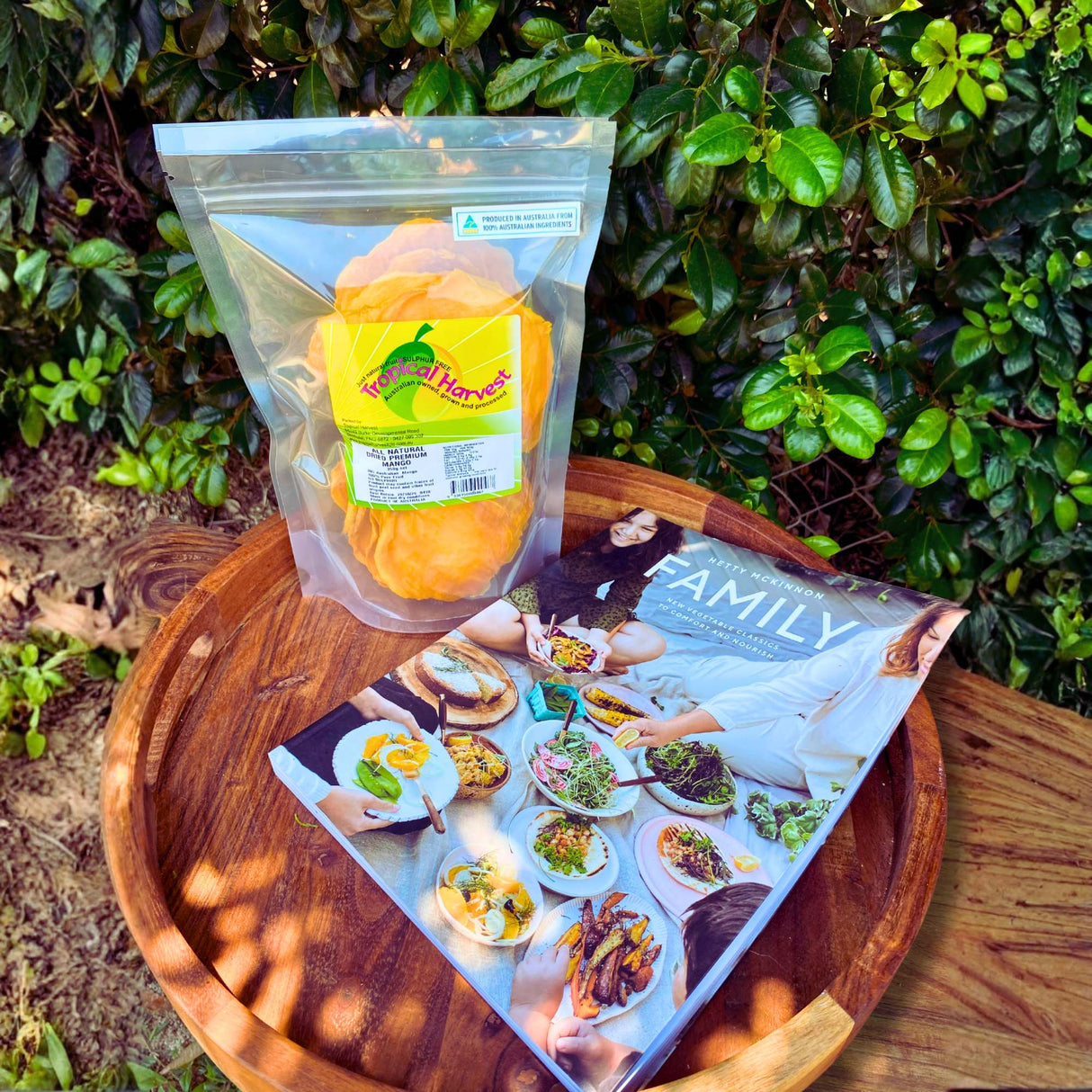 Dried mango and Family cookbook by Hetty McKinnon gift bundle flatlay on wooden tray – Christmas foodie gift set