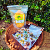 Dried mango and Family cookbook by Hetty McKinnon gift bundle flatlay on wooden tray – Christmas foodie gift set