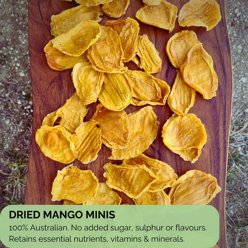 Flatlay of dried mango minis on a wooden board with text overlay highlighting 100% Australian-grown fruit, free from added sugar, sulphur, or flavours. Emphasises natural nutrient retention and clean ingredients.