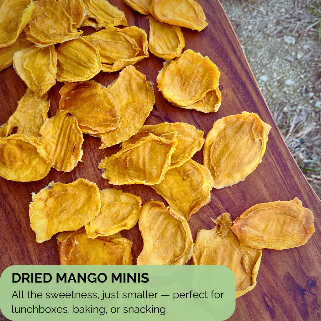 Top-down view of dried mango minis spread on a wooden board with text overlay describing their snack-sized convenience — ideal for lunchboxes, baking, or on-the-go snacking.