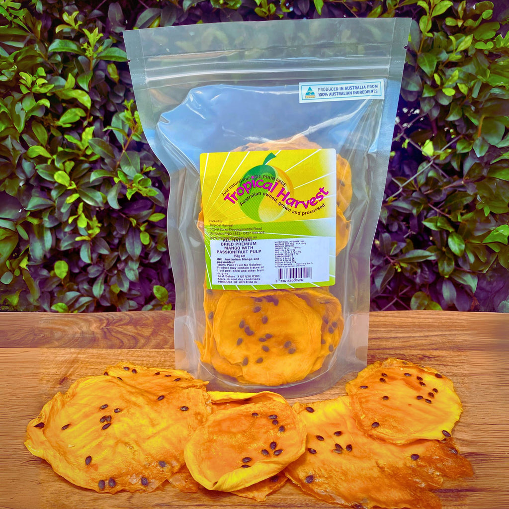 Dried passionfruit mango 350g pack with visible product label showing sulphur-free, Australian-grown ingredients and resealable packaging. Large upright bag of dried mango infused with real passionfruit, with seed-speckled slices displayed in front on a wooden surface.