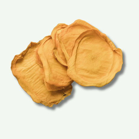 Loose slices of Green Australian dried mango showing pale colour and natural firmness.