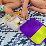 Child eating dried fruit mix from lunchbox as a healthy snack option for kids