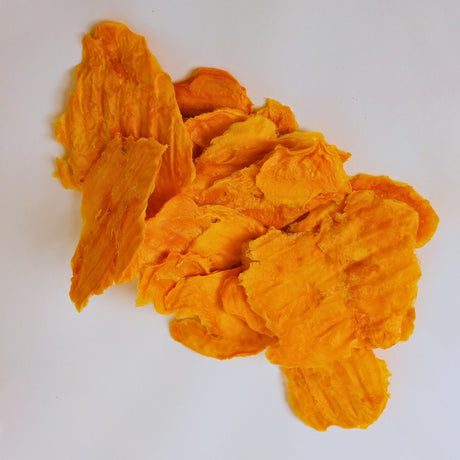 Standard Australian dried mango slices showing natural colour variation and lightly graded texture.