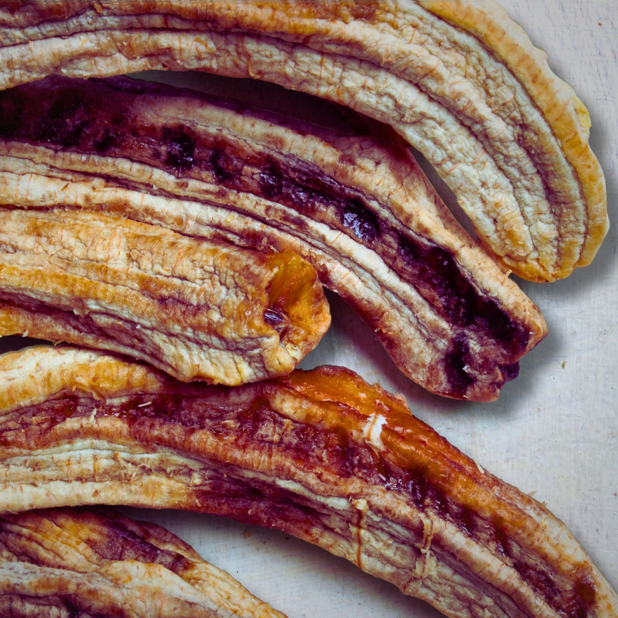 Close-up of whole dried Australian bananas showing chewy texture and natural caramelisation. 100% fruit, no sugar or sulphites.
