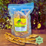 570g Tropical Harvest dried banana lime resealable bag with chewy banana strips shown on wooden background. Bright, zesty flavour for families.