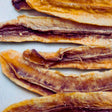 Close-up of Tropical Harvest dried banana long slices showing natural caramelisation and chewy texture. 100% Australian fruit, no additives.