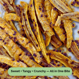 Close-up of Tropical Harvest dried banana strips drizzled with real passionfruit pulp and seeds. Sweet, tangy, and crunchy texture — 100% Australian-grown fruit.