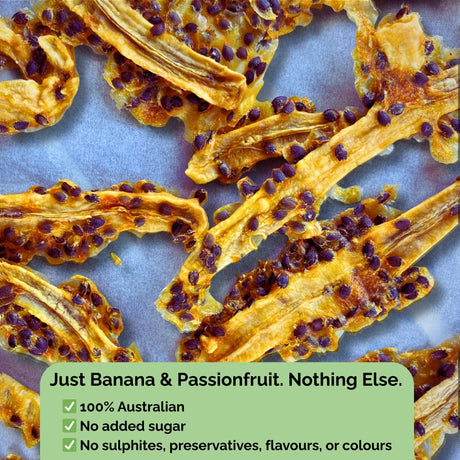 Dried banana strips with passionfruit pulp and seeds on a baking sheet. Text overlay: “Just Banana & Passionfruit. Nothing Else.” No sugar, no sulphites, no preservatives.