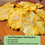 Tropical Harvest dried pineapple flowers with text overlay: "Just Pineapple. Nothing Else." No added sugar, sulphites, preservatives, or colours.