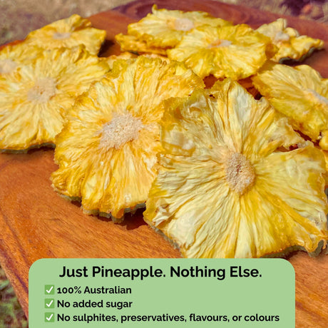 Tropical Harvest dried pineapple flowers with text overlay: "Just Pineapple. Nothing Else." No added sugar, sulphites, preservatives, or colours.