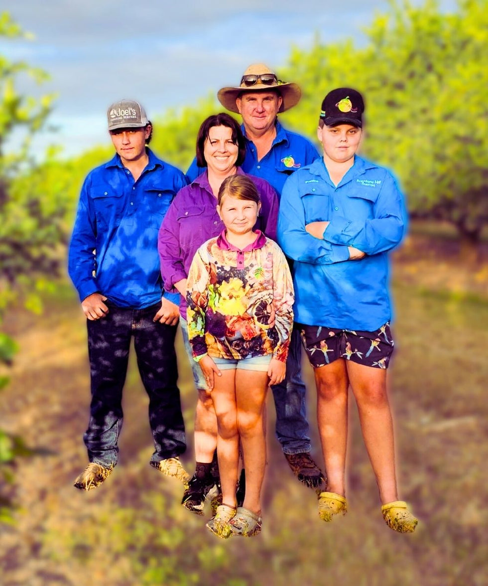 The Tropical Harvest family standing together on their North Queensland farm, growers of Australian dried fruit.