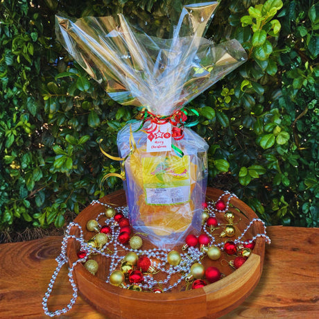 Wrapped Christmas gift set with dried mango and cookbook – festive foodie gift idea with decorations